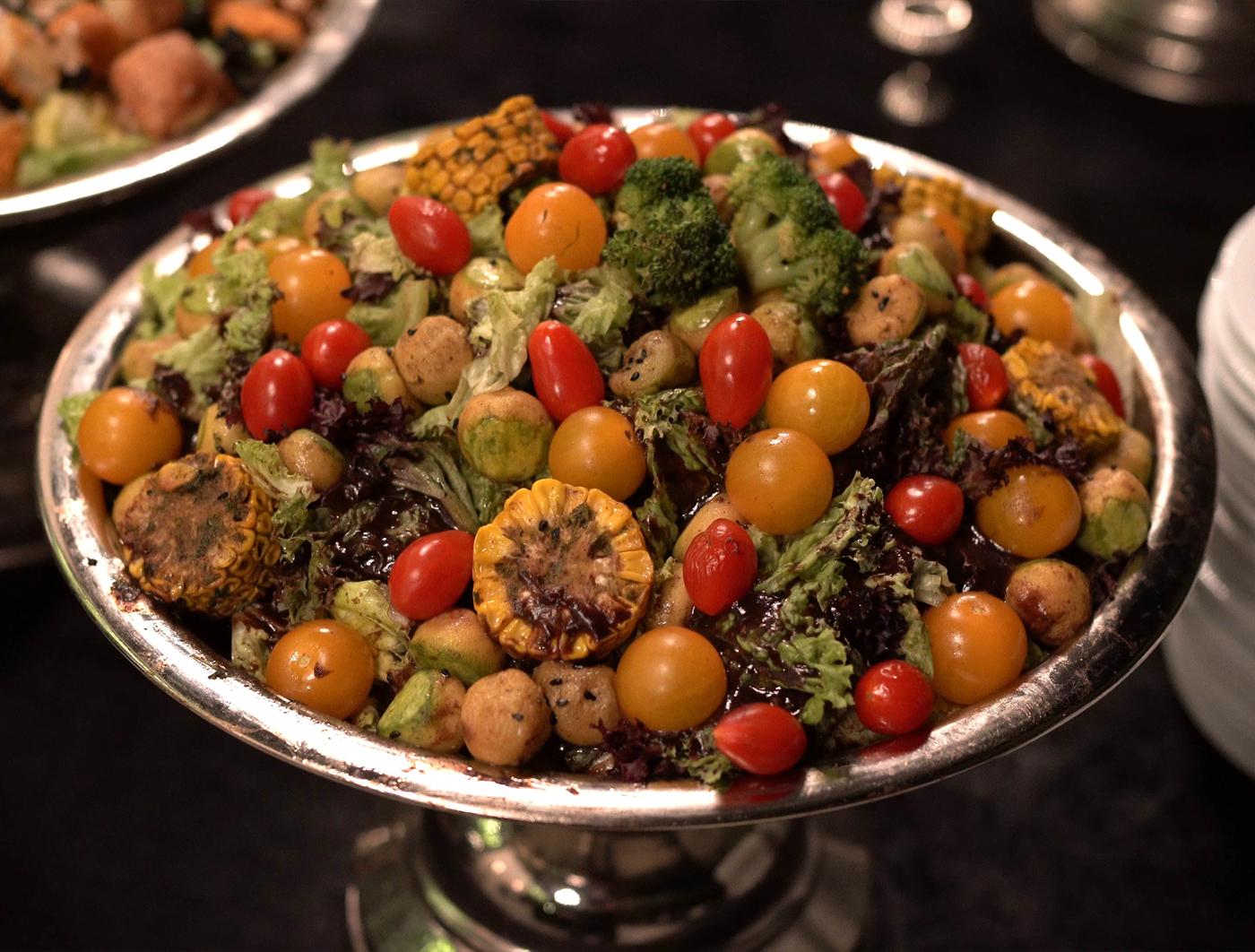 Fresh salad with greens, tomatoes, and dressing