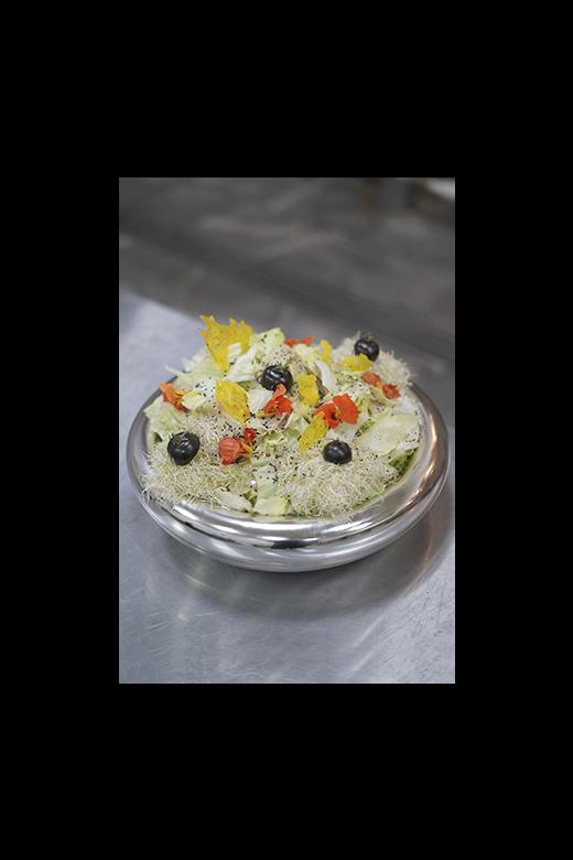 Fresh salad with greens, tomatoes, and dressing